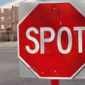 Stop sign that reads SPOT.